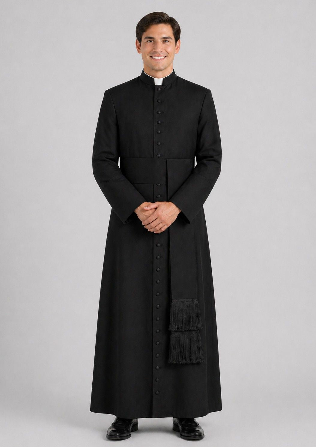 Man wearing a black cassock on a gray background