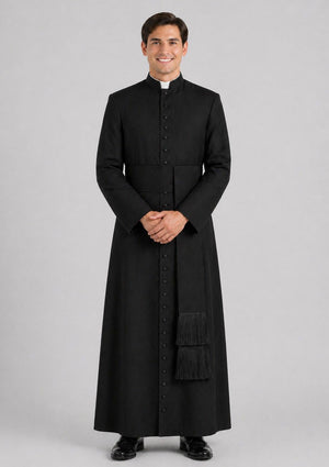 Man wearing a black cassock on a gray background