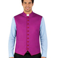 Man wearing a purple vest with re trim over a light blue shirt on a white background.