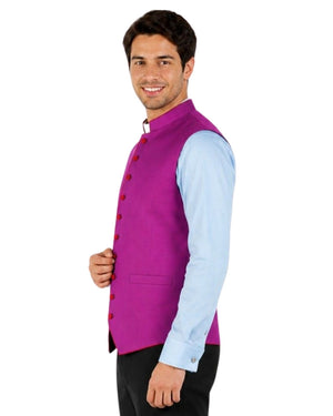 Man wearing a purple vest with re trim over a light blue shirt on a white background.
