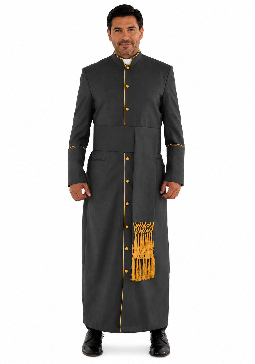 Man wearing a long dark robe with gold buttons and trim on a white background