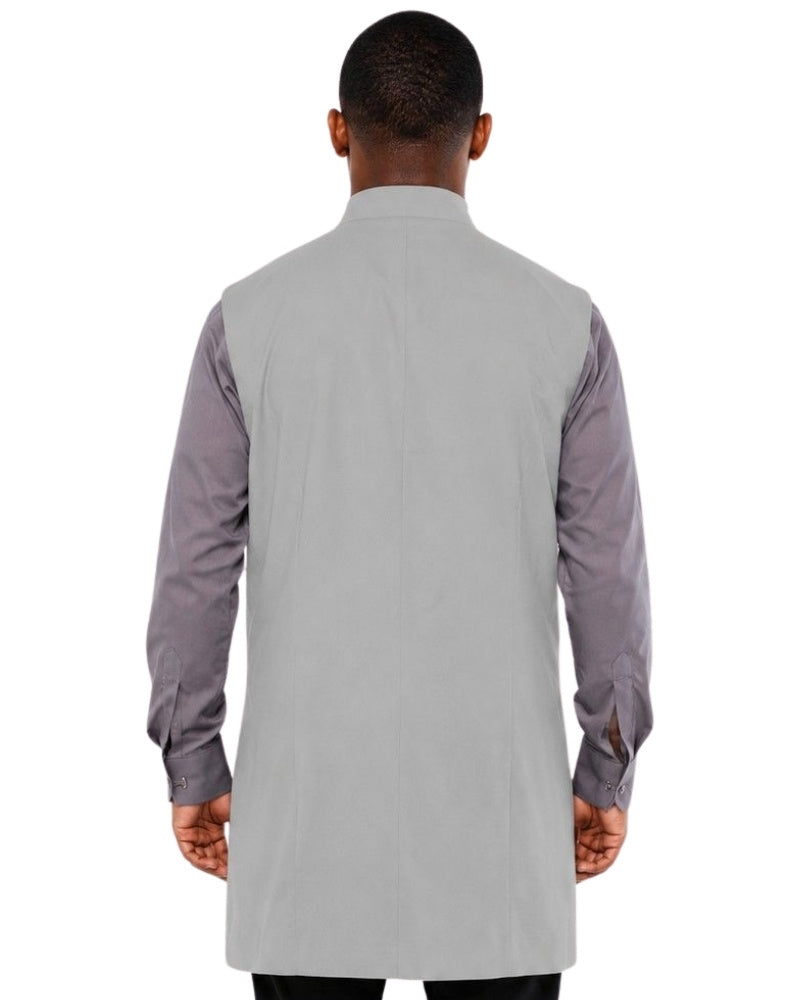 Man wearing a gray vest over a shirt on a white background