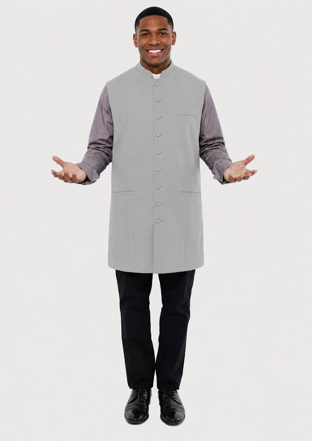 Man wearing a gray vest over a long-sleeve shirt on a white background
