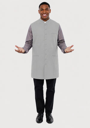 Man wearing a gray vest over a long-sleeve shirt on a white background