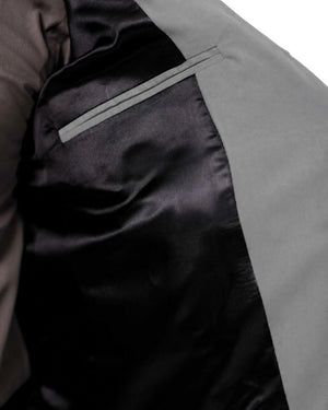 Man wearing a gray vest over a shirt on a white background