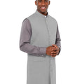 Man wearing a gray vest over a shirt on a white background