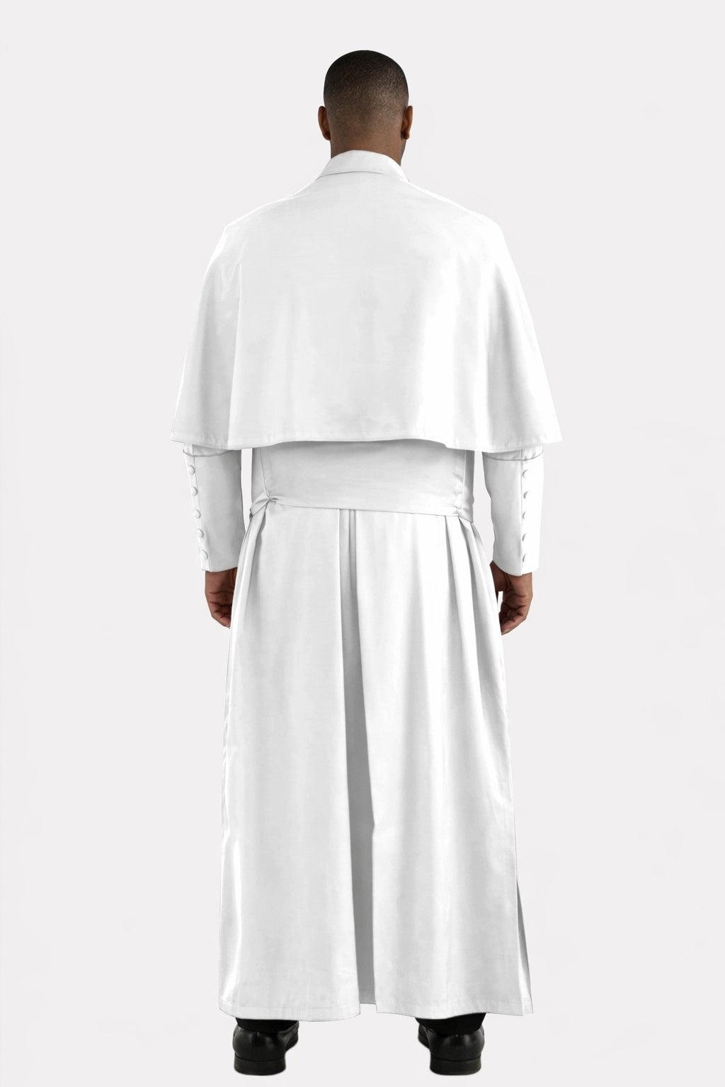 Person wearing a white outfit with a long white robe on a white background