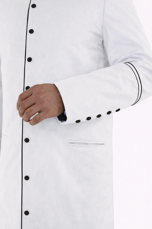 Close-up of a white robe with black buttons and trim.