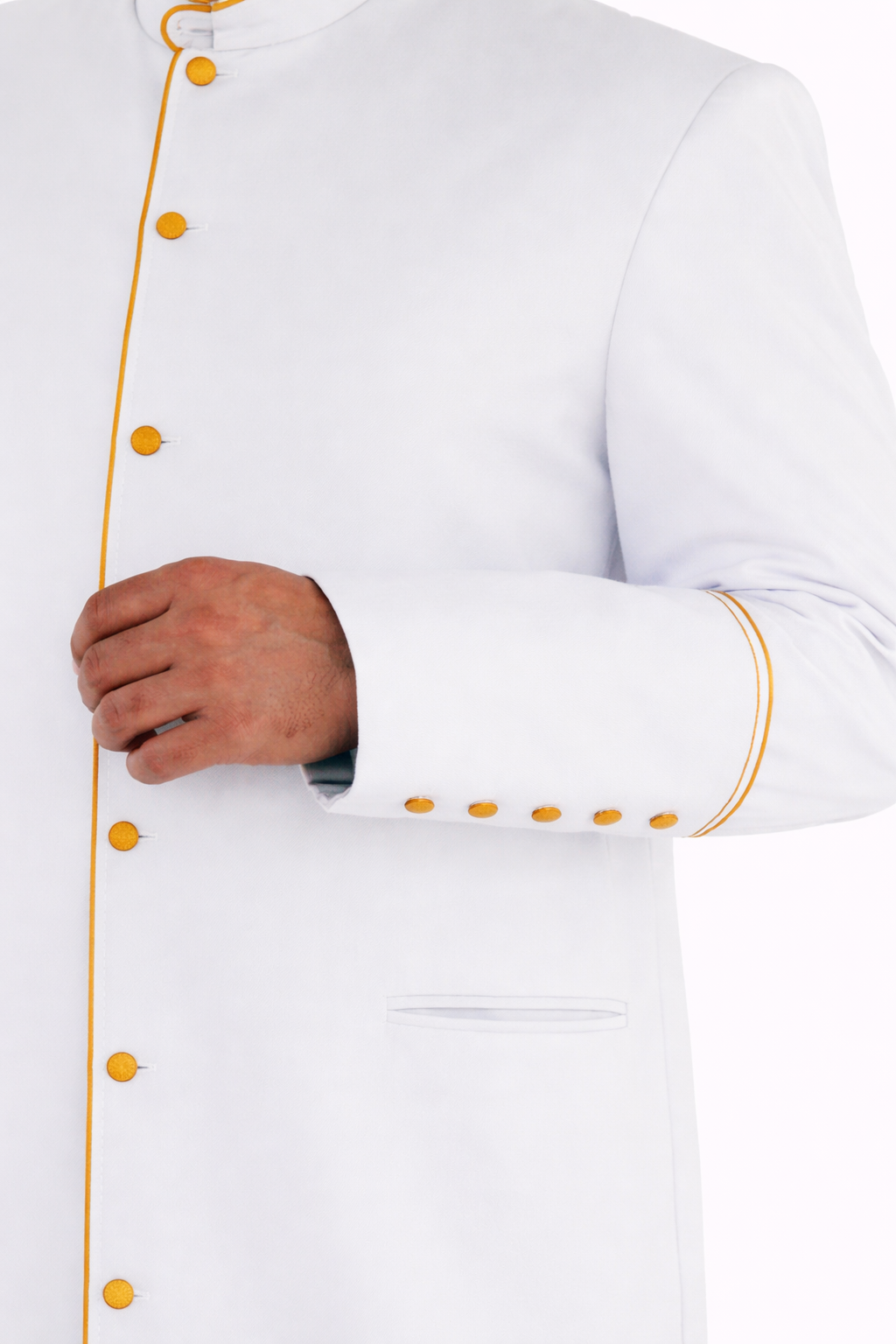 white robe with the golden accents cuffs close up on the white background 
