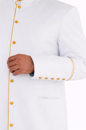 white robe with the golden accents cuffs close up on the white background 
