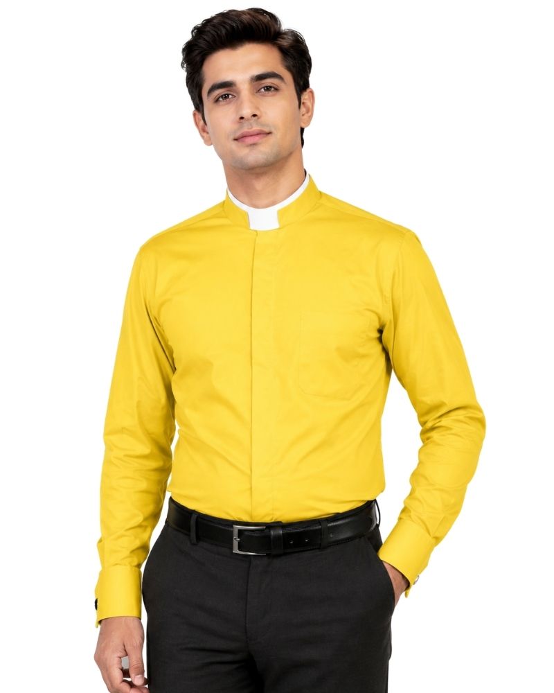 A man wearing a bright yellow long-sleeve clerical shirt with a white clerical collar, paired with black trousers and a black belt, against a plain white background.