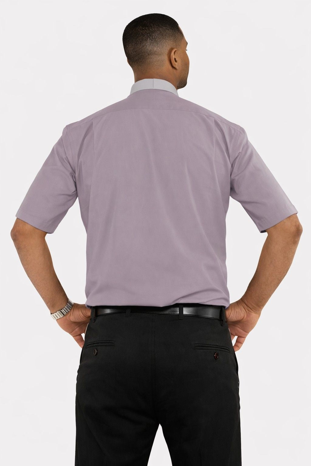 Man wearing a gray clergy shirt and black pants on a white background