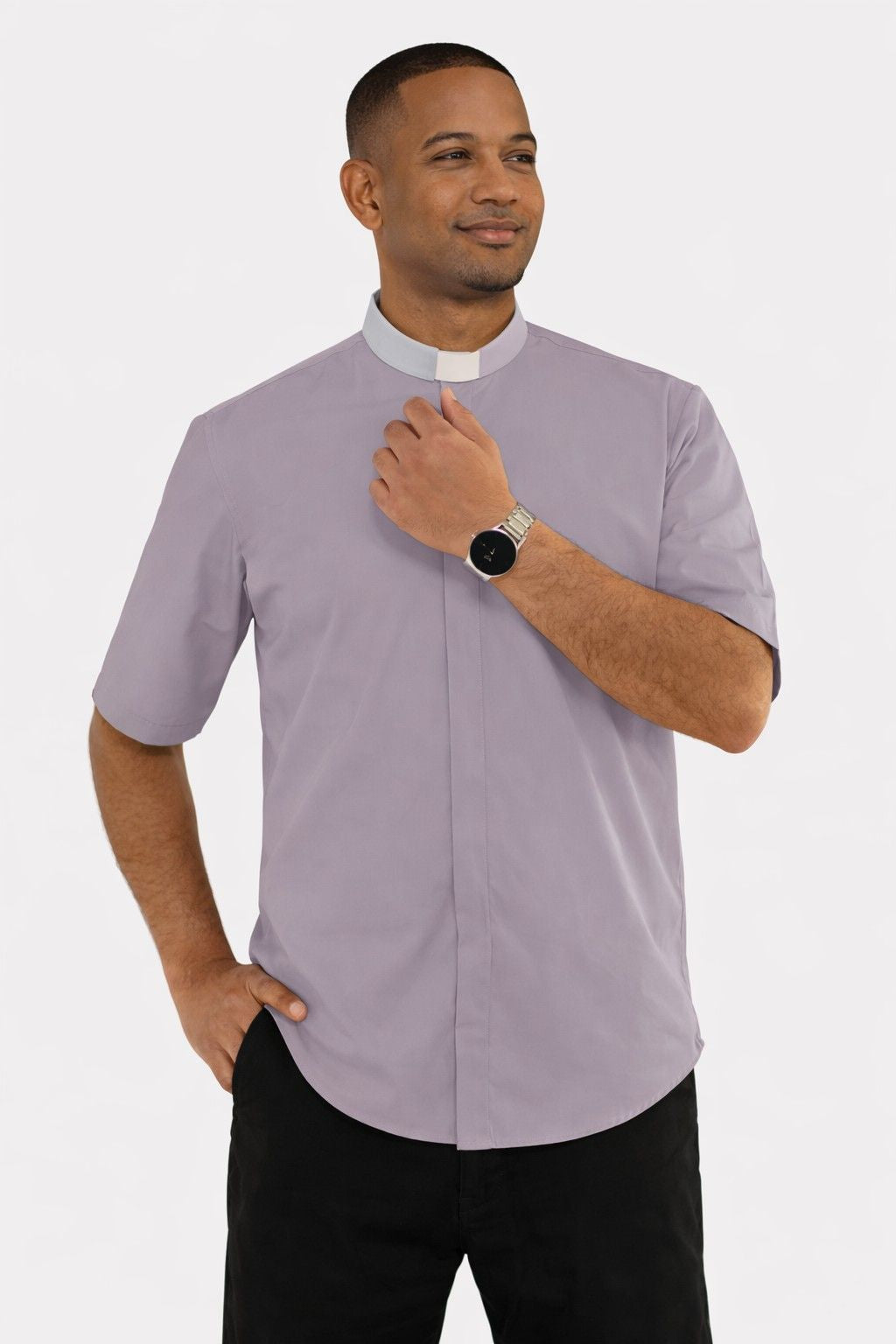Man wearing a gray clergy shirt with a white collar on a white background