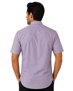 Man wearing gray clerical shirt on white background.