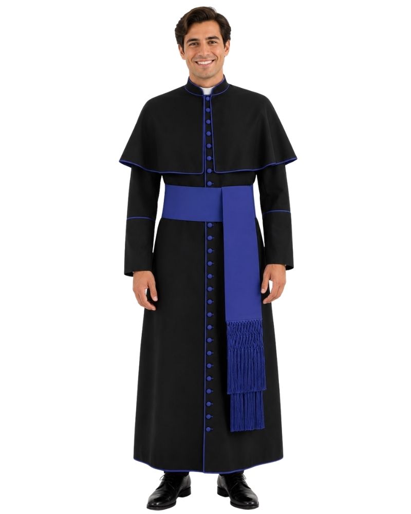 A man modeling a black papal collar cassock with royal blue trim, a matching blue sash, and a blue fringed stole, set against a plain white background.