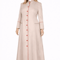 Woman wearing a long beige robe with red buttons on a white background