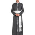 A man modeling a dark gray priestly cassock with a white waist sash, white collar, and white decorative fringes, set against a plain white background.
