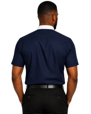 A man viewed from the back wearing a navy blue short-sleeve polo shirt, a white collared shirt underneath, a black belt, and black trousers, set against a plain white background.
