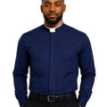 A man wearing a navy blue long-sleeve clerical shirt with a white collar tab, paired with black trousers and a black belt, against a plain white background.