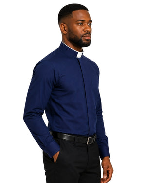A man wearing a navy blue long-sleeve clerical shirt with a white clerical collar, paired with black trousers and a black belt, shown in a side-profile view against a plain white background.