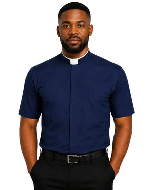 A man wearing a navy blue short-sleeve clerical shirt with a white collar tab, paired with black trousers and a black belt, against a plain white background.