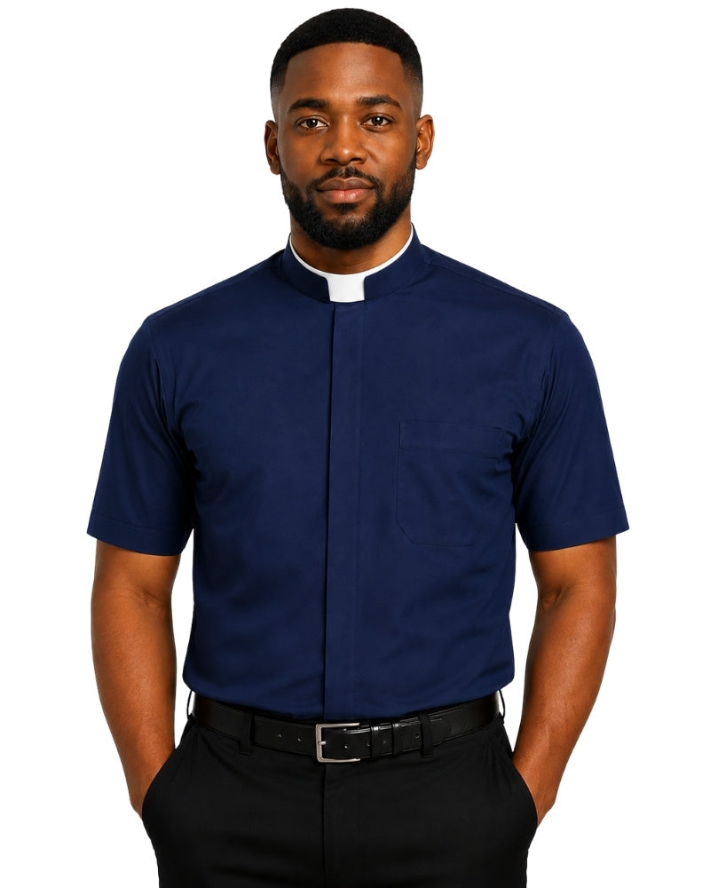 A man wearing a navy blue short-sleeve clerical shirt with a white collar tab, paired with black trousers and a black belt, against a plain white background.