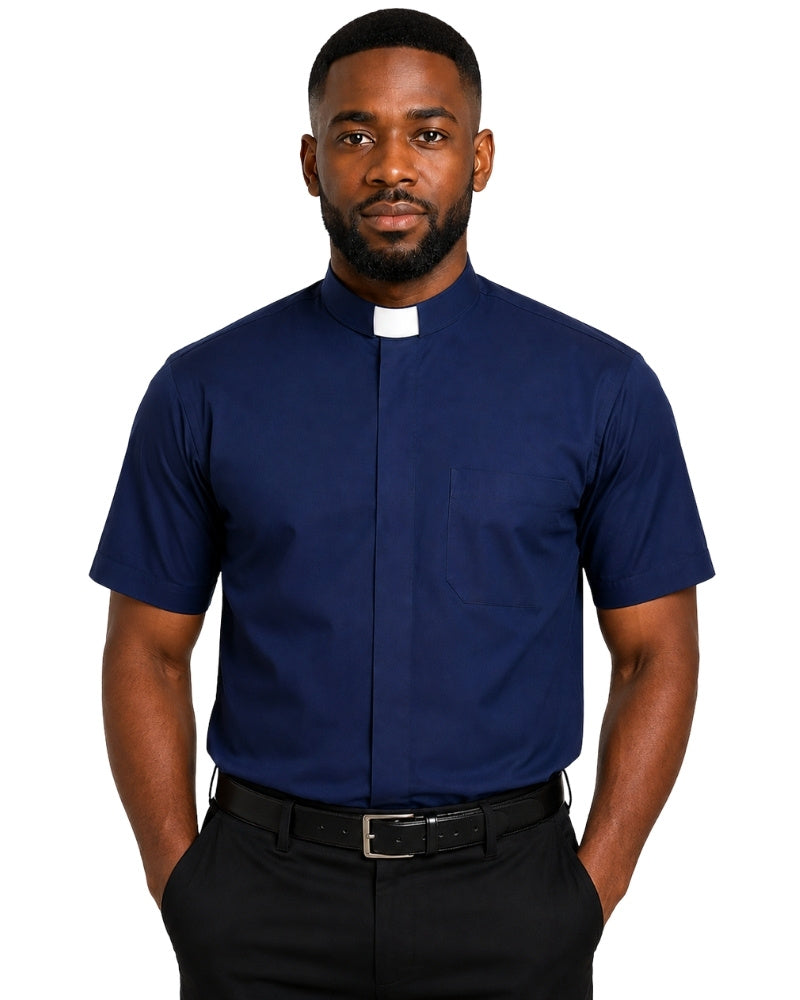 A man wearing a navy blue short-sleeve clerical shirt with a white collar tab, paired with black trousers and a black belt, against a plain white background.