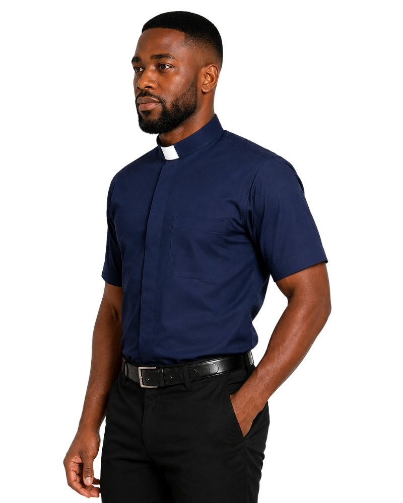 A man wearing a navy blue short-sleeve clerical shirt with a white collar tab, paired with black trousers and a black belt, shown against a plain white background.