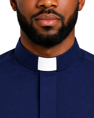 A close-up of a man wearing a navy blue clerical shirt with a white collar tab, shown from the nose down against a plain white background.
