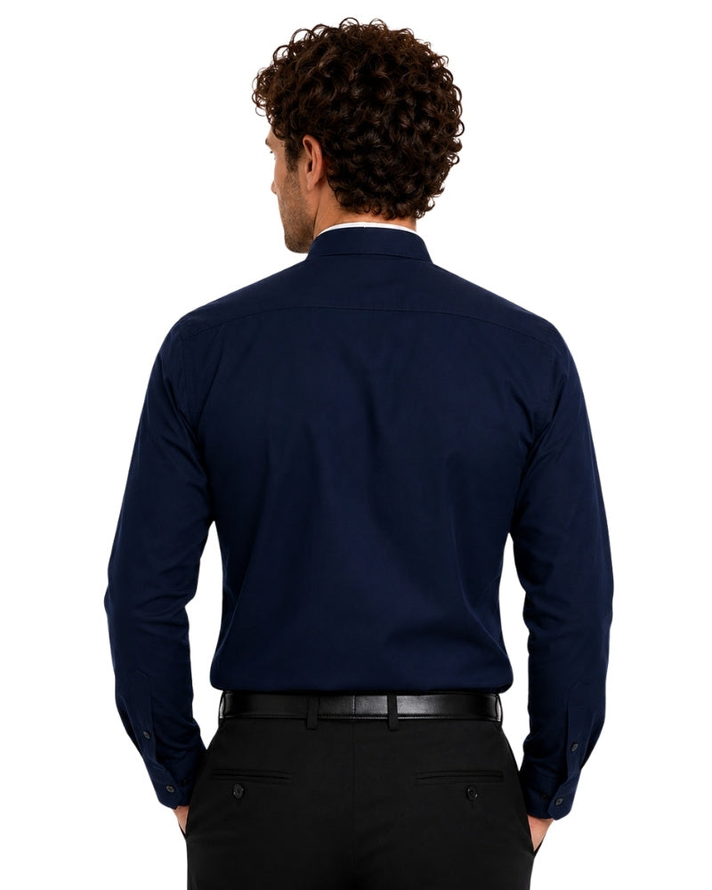 Man wearing a navy blue clerical shirt with a white collar on a white background