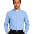 Man wearing a light blue clerical shirt on a white background