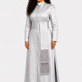 Woman wearing a long light gray robe with a fringed detail on a white background