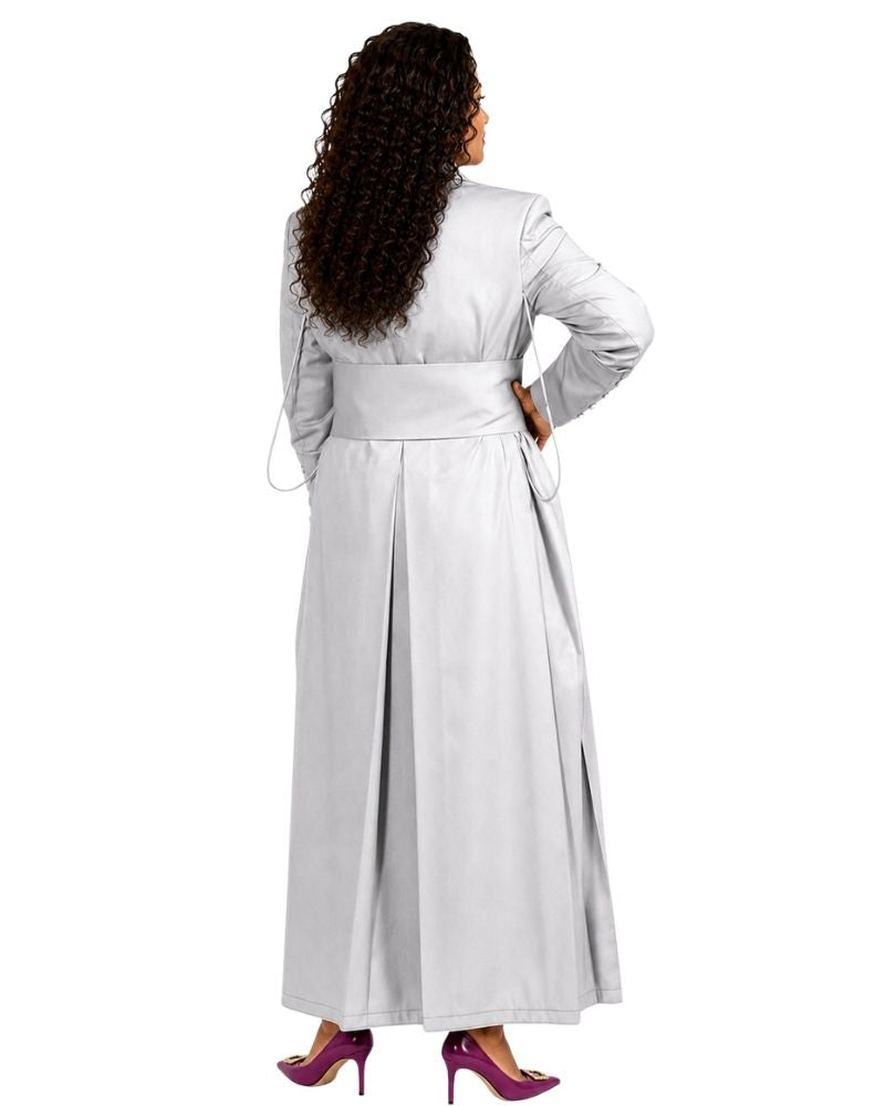 A woman viewed from the back wearing a long white cassock with a wide waist belt and long sleeves, paired with purple high heels, against a plain white background.