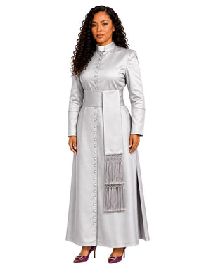 A woman modeling a long-sleeved silver satin cassock with a high collar, buttoned front, a wide waist sash, and a decorative silver fringe panel on the skirt, set against a plain white background.