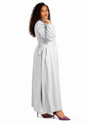 Woman wearing a long light gray robe with a belt on a white background