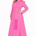 Woman wearing a pink robe with a white collar on a white background