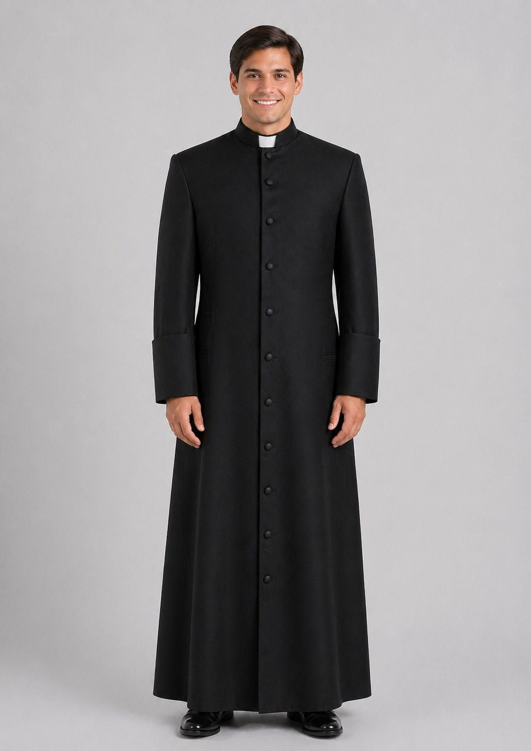 Priest wearing a black cassock on a gray background