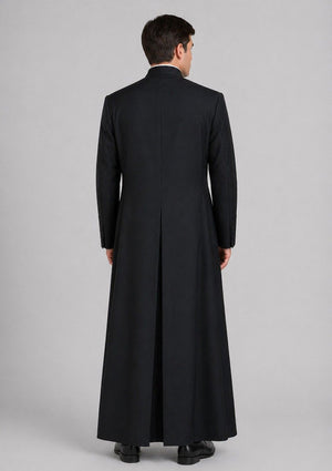 Man wearing a long black coat on a gray background