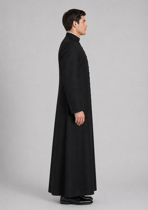 Man wearing a long black coat on a gray background