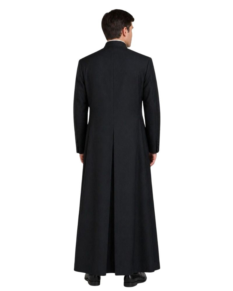 A man viewed from the back wearing a long black robe over a dark suit, standing against a plain white background.
