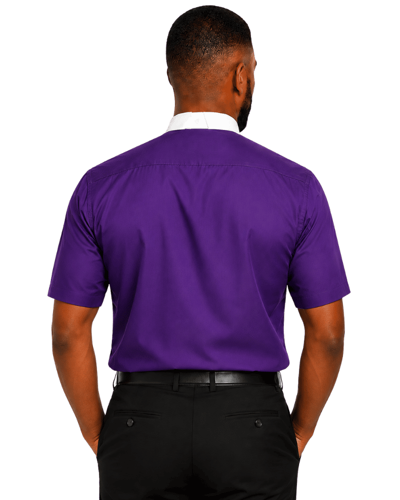 A man viewed from the back wearing a purple short-sleeve clerical shirt over a white collared undershirt, paired with black trousers and a black belt, against a plain white background.