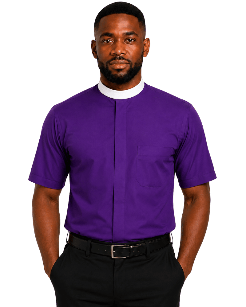 A man wearing a purple short-sleeve clerical shirt with a white collar, paired with black trousers and a black belt, standing against a solid white background.