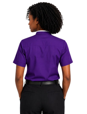 A woman viewed from the back wearing a short-sleeve purple clerical shirt and black bottoms, set against a plain white background.