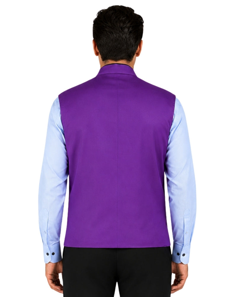 Man wearing a purple vest over a light blue shirt with black pants on a white background.