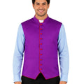 Man wearing a purple vest over a light blue shirt with black pants on a white background.