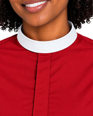 Close-up of a woman wearing a red clerical shirt with a white collar, showing the neck, lower face, and upper chest against a white background.