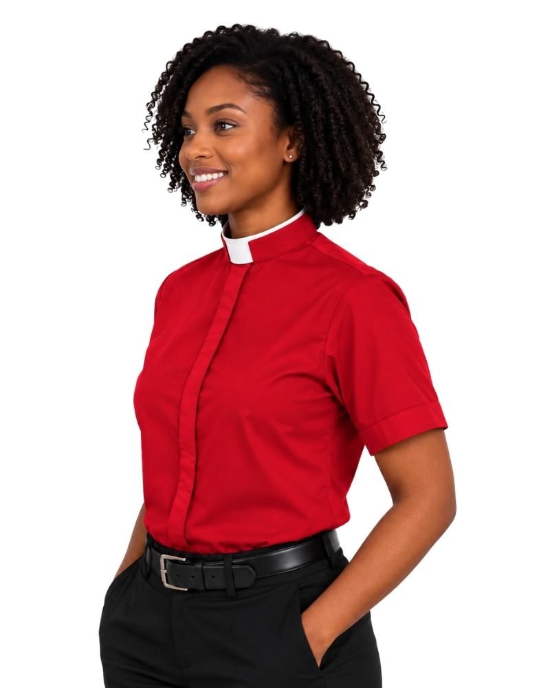 A woman wearing a red short-sleeve clerical shirt with a white collar, paired with black trousers and a black belt, shown against a plain white background.