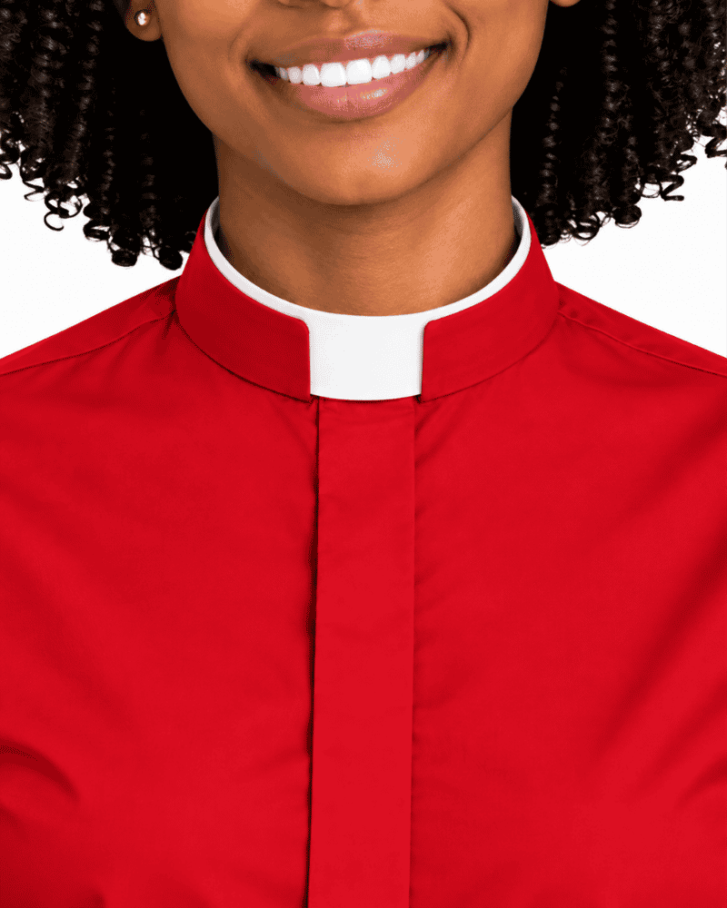 A close-up of a woman wearing a red clerical shirt with a white collar, shown from the chest up against a plain white background.