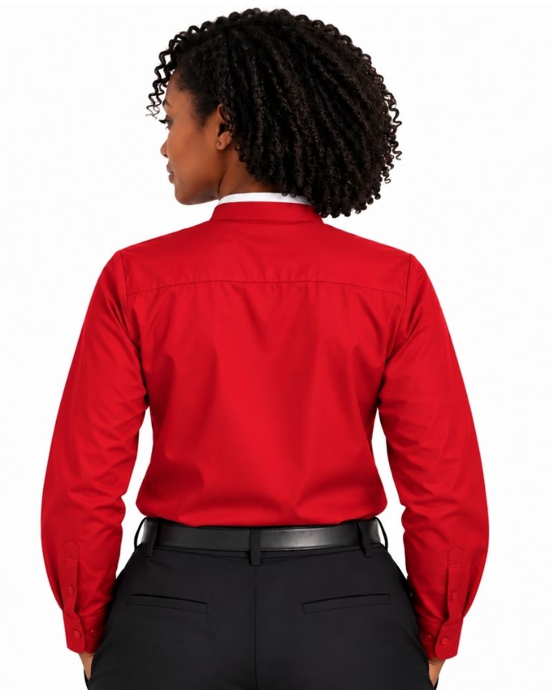 A woman shown from the back wearing a long-sleeve red clerical shirt tucked into black pants, against a plain white background.