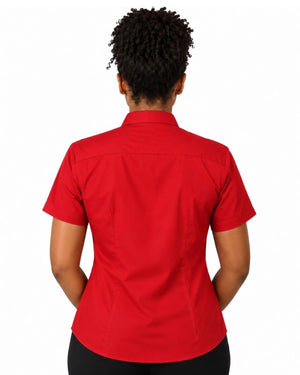 A woman viewed from the back wearing a short-sleeve red clerical shirt and black pants, set against a plain white background.